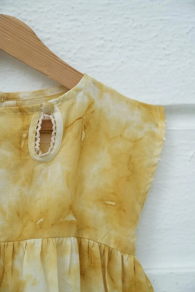 Turmeric Hues’ girls dress in ochre yellow hand tie dye