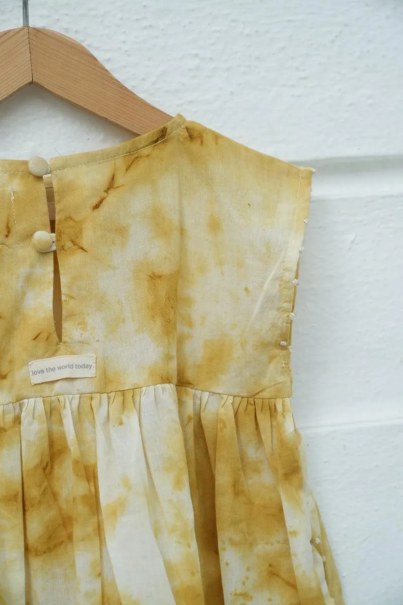 Turmeric Hues’ girls dress in ochre yellow hand tie dye