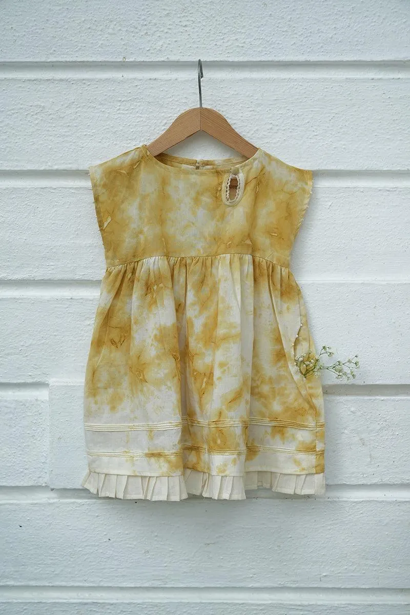 Turmeric Hues’ girls dress in ochre yellow hand tie dye