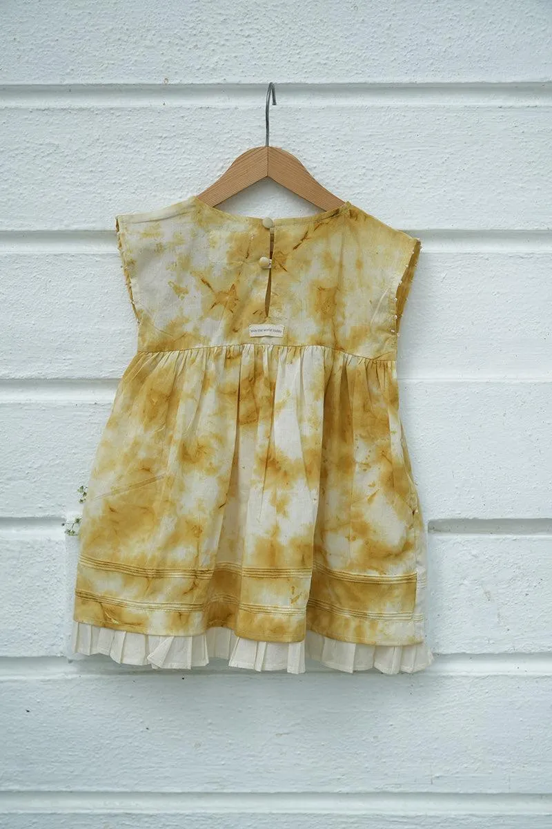 Turmeric Hues’ girls dress in ochre yellow hand tie dye