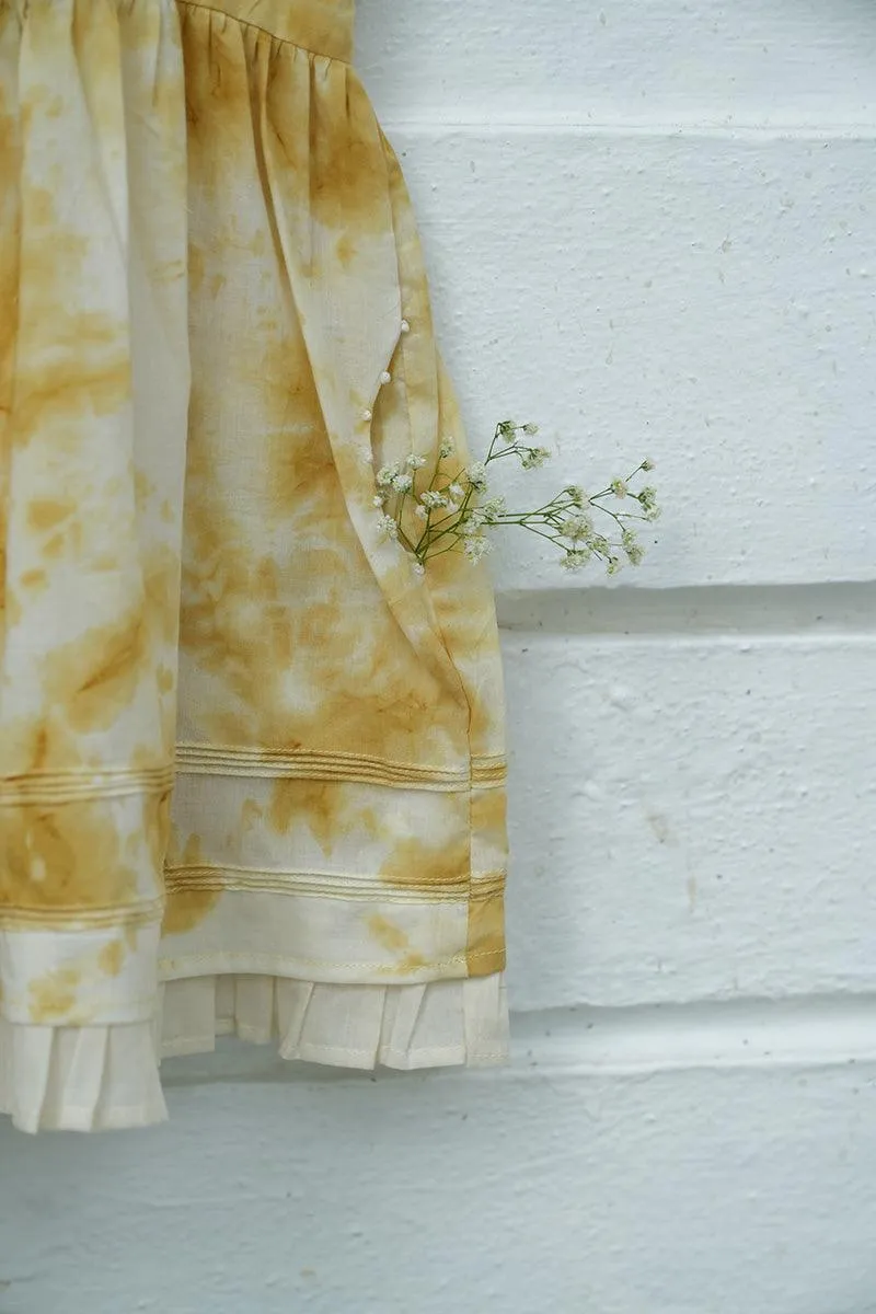 Turmeric Hues’ girls dress in ochre yellow hand tie dye